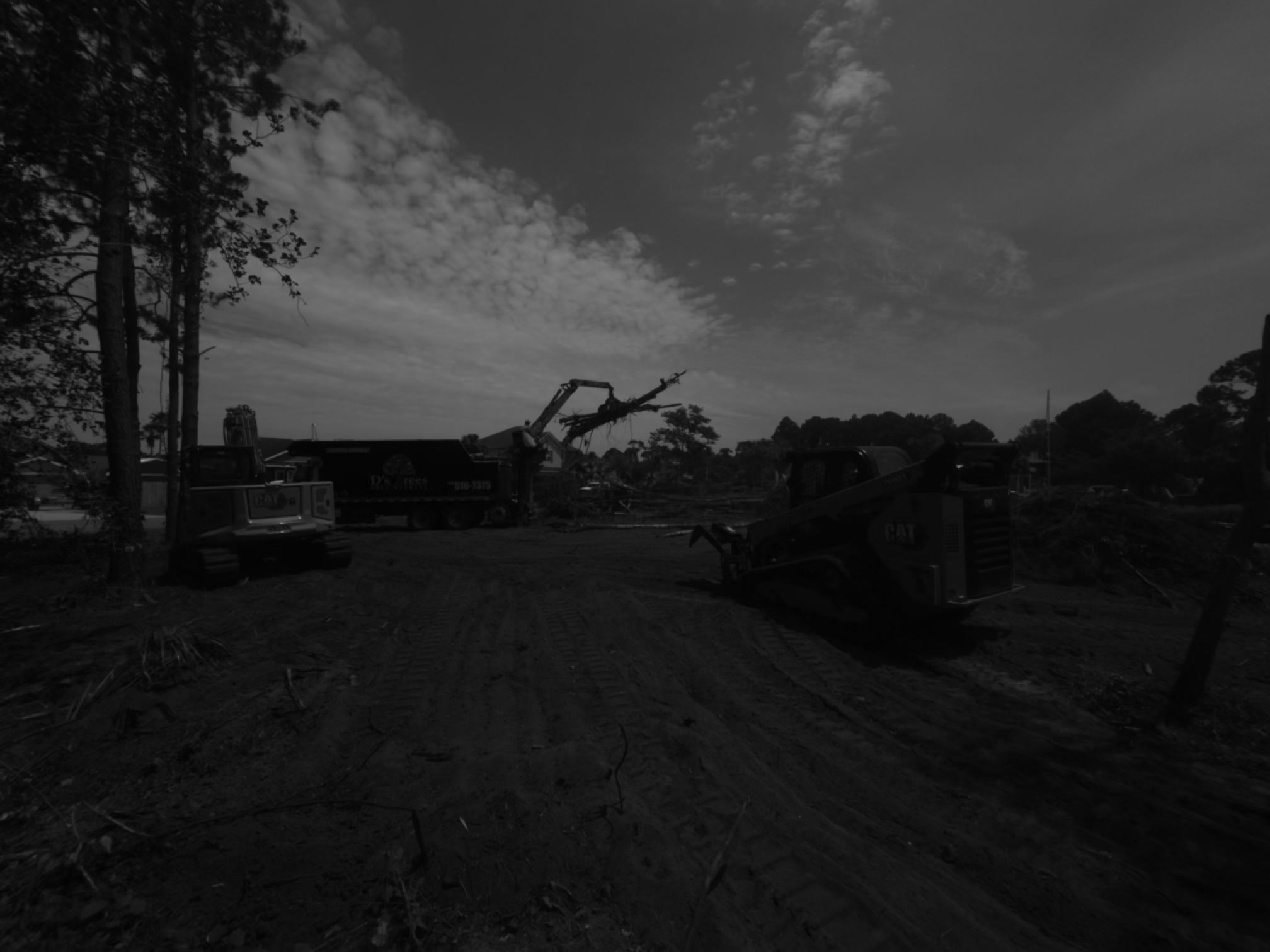 SKS Aquatic equipment clearing land and loading debris for removal