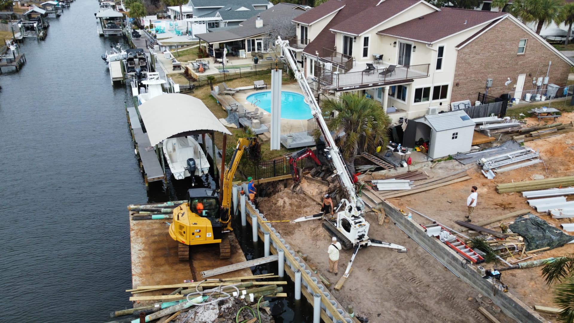 Aerial view of seawall construction using an SKS Aquatic crane and barge