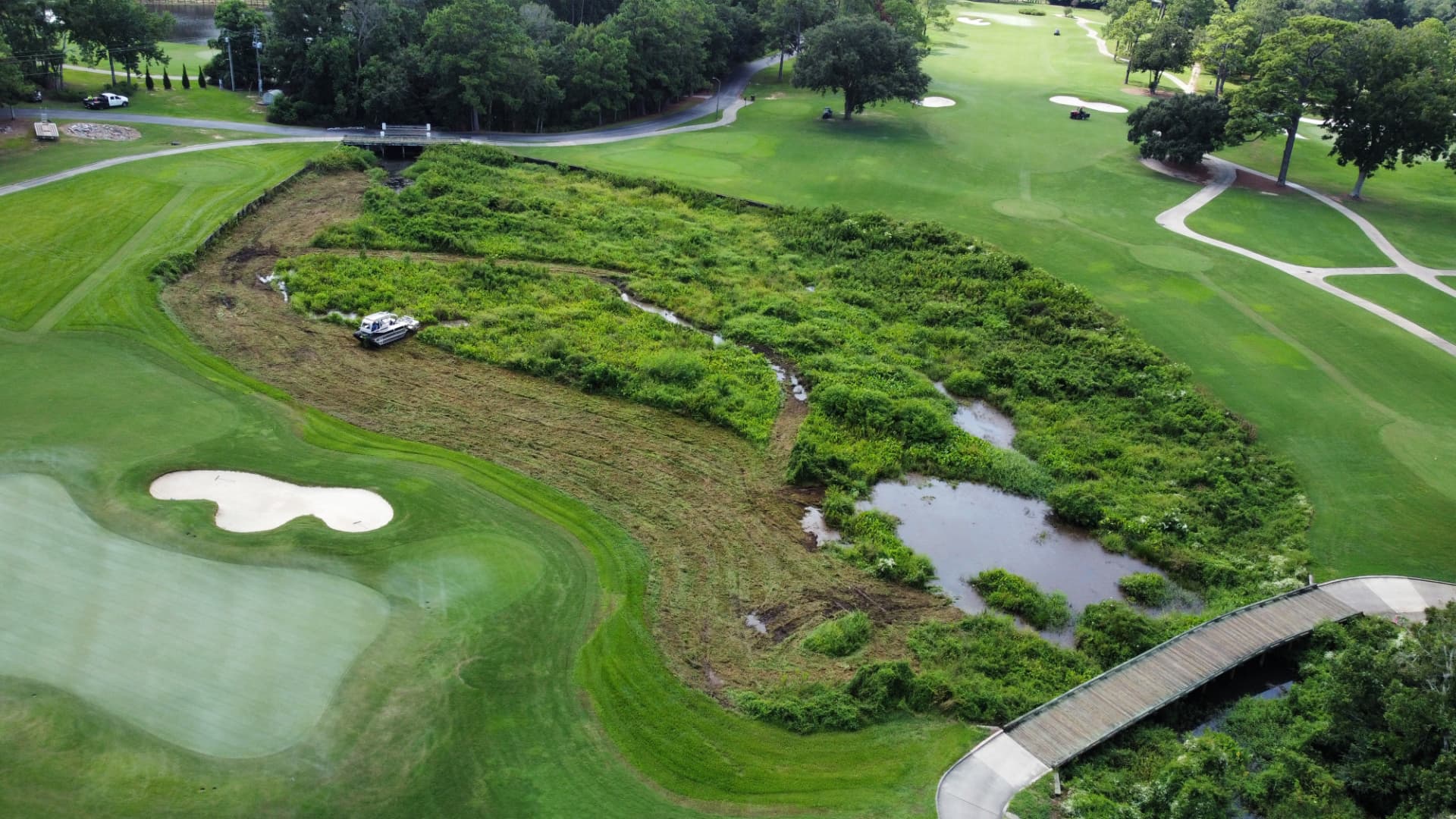 Aerial view of SKS Aquatic mowing an overgrown golf course wetland