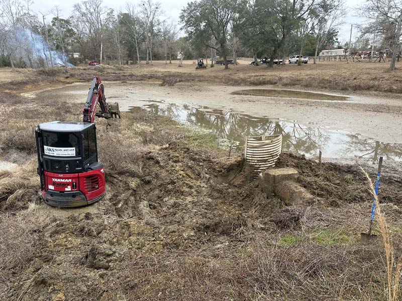 SKS Aquatic excavators removing accumulated sediment from a pond