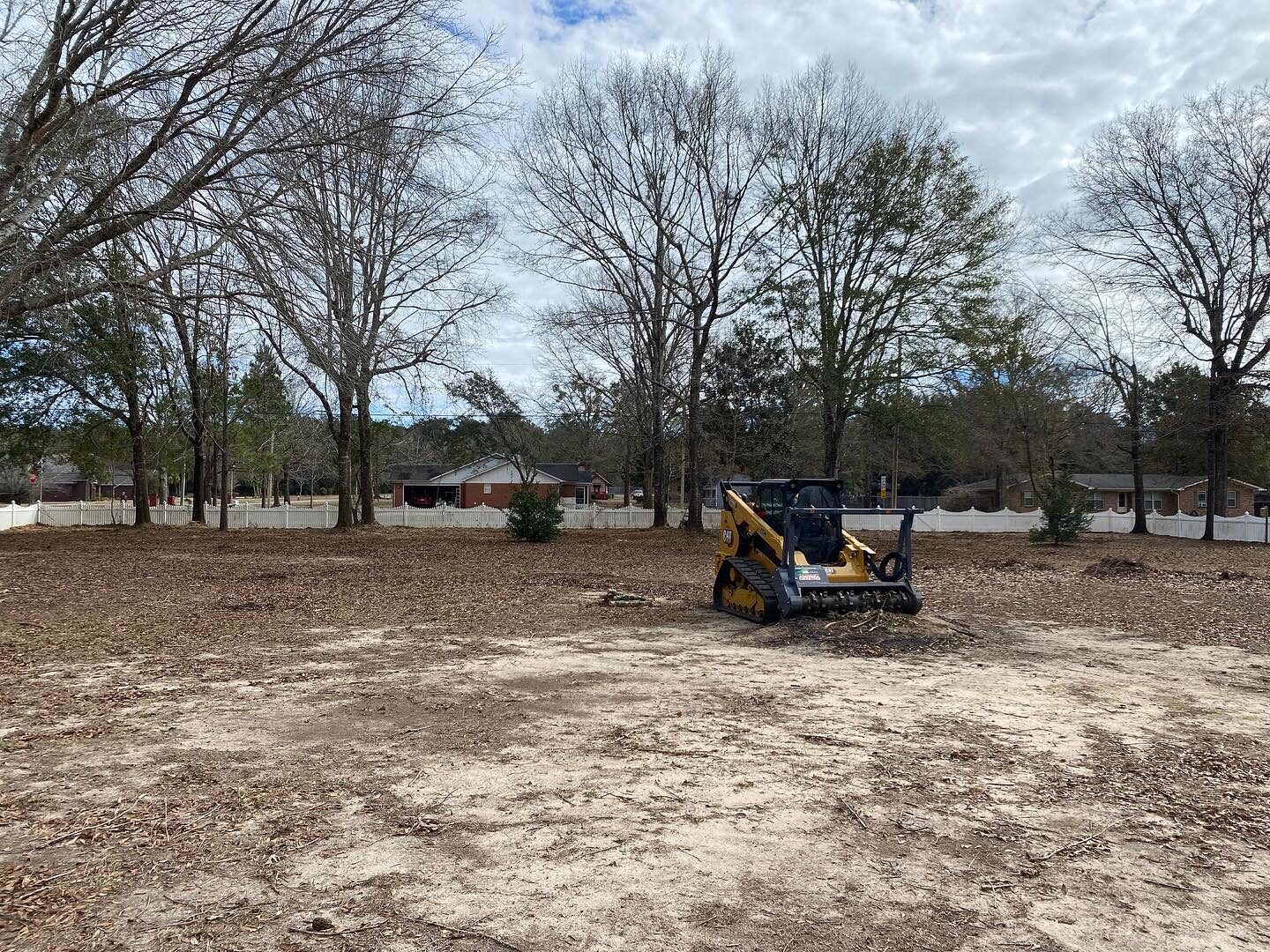 Tracked mulching machine clearing dense brush and small timber on a Northwest Florida acreage tract