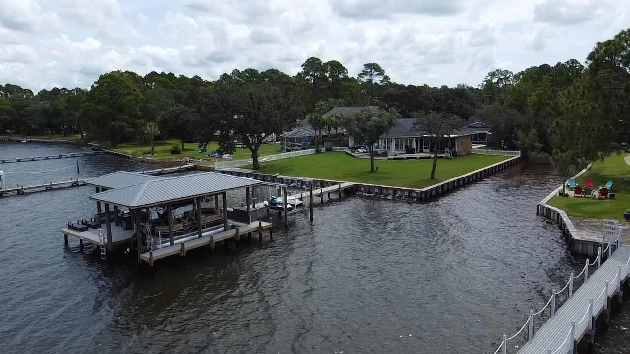 Aerial view of an SKS Aquatic boathouse and waterfront seawall