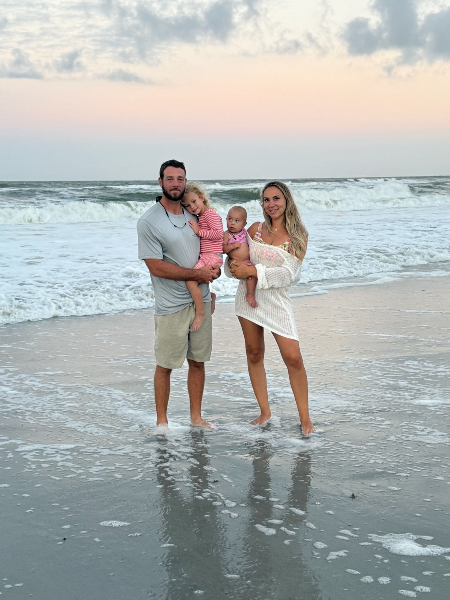 SKS Aquatic owner Scott Laughlin with his wife and three daughters on the beach at sunset