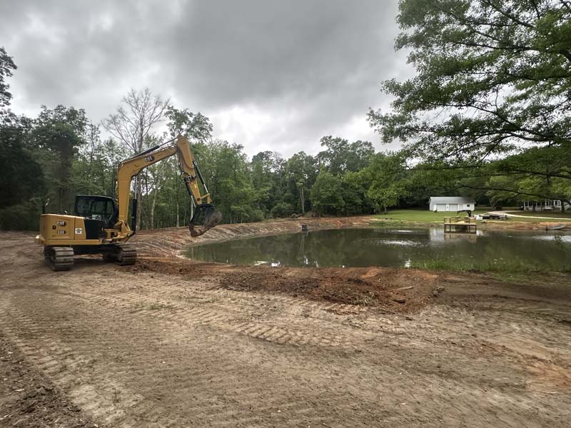 SKS Aquatic excavator shaping and restoring a residential pond bank