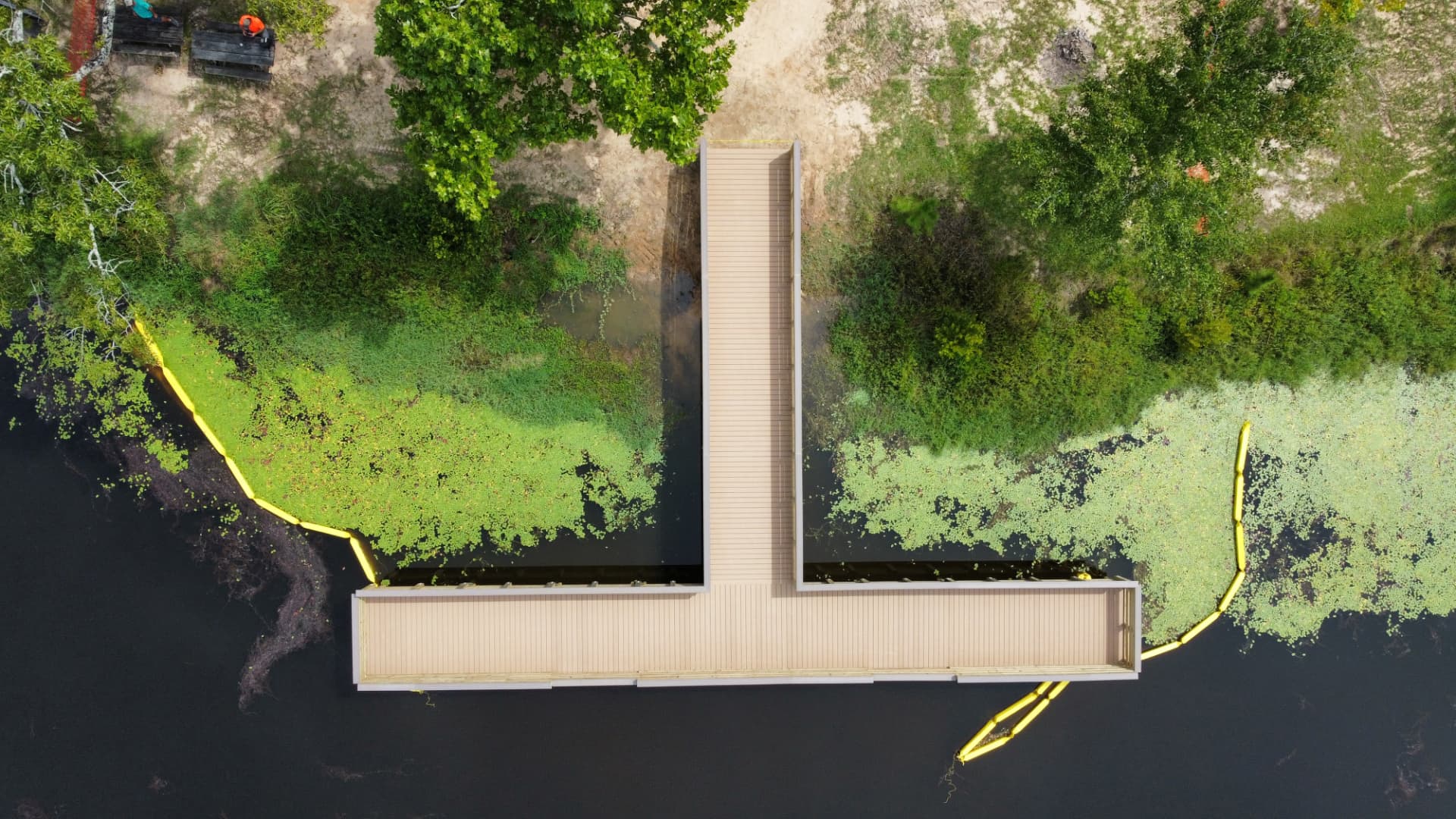 Overhead drone view of a completed T-shaped lake boardwalk