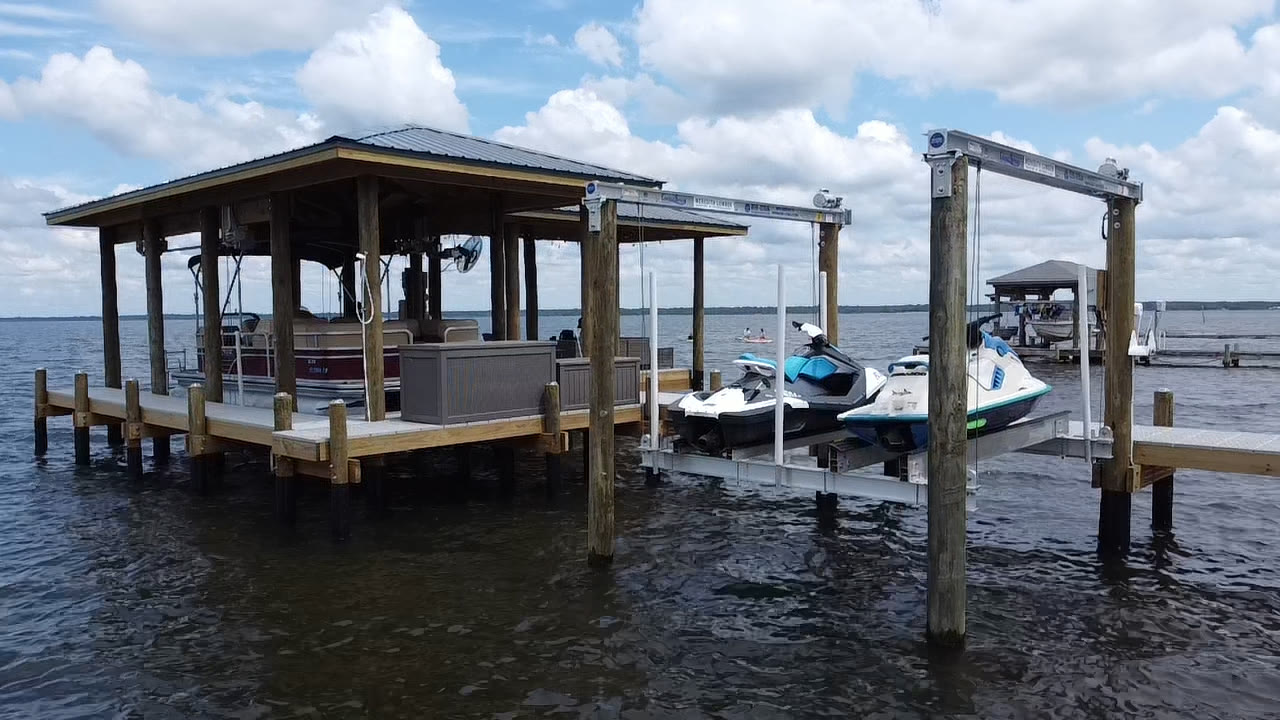 Covered dock with boat lift and PWC lifts built by SKS Aquatic