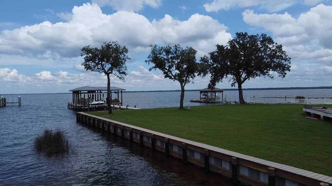 Completed SKS Aquatic seawall along a landscaped waterfront lawn
